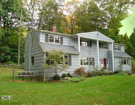 60 Mimosa Circle Ridgefield, CT 06877 - Photo 1 of 1 a front view of a house with a garden