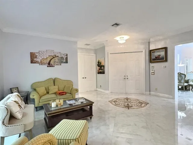 a kitchen with granite countertop a stove a sink dishwasher a refrigerator and wooden cabinets with wooden floor