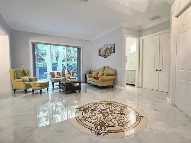 a view of a sink and a refrigerator in a kitchen