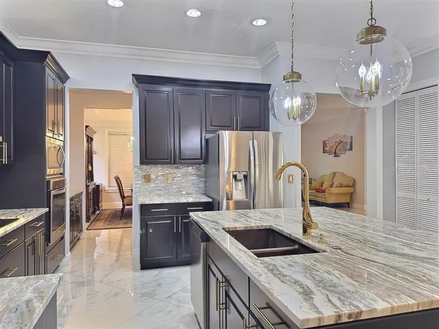 a kitchen with stainless steel appliances granite countertop a stove and a sink