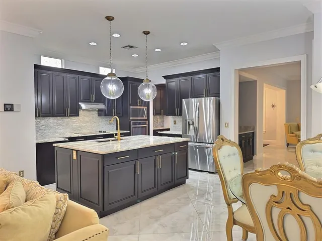 a dining room with furniture a chandelier and window