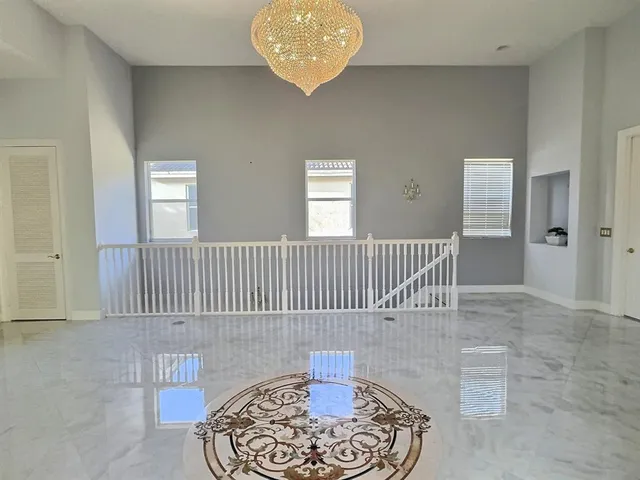 a room with a black white checkered table and a potted plant
