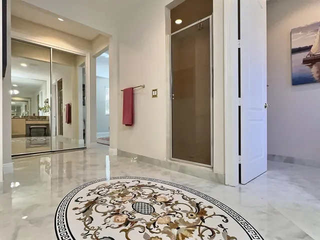 a bathroom with a granite countertop double vanity sink a mirror and a toilet