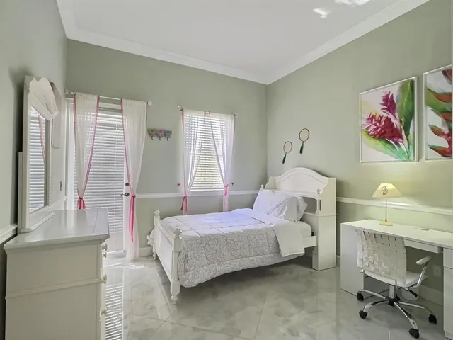 a bedroom with furniture and a window