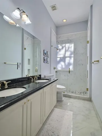 a bathroom with a toilet and a shower