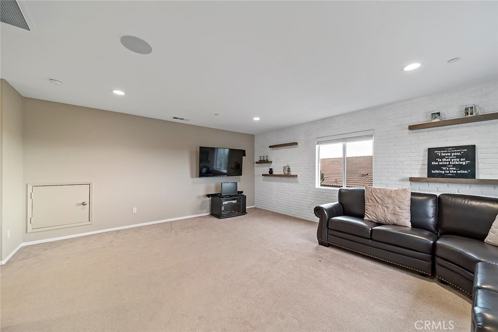 1189 Heritage Drive Calimesa, CA 92320 - Photo 15 of 36 a living room with furniture and a flat screen tv