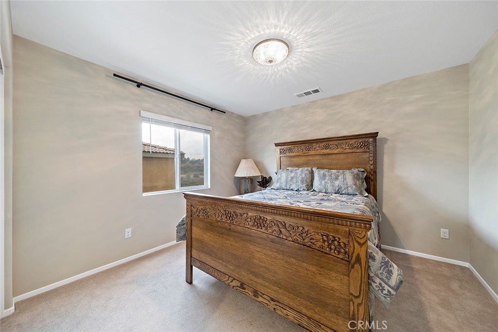 1189 Heritage Drive Calimesa, CA 92320 - Photo 17 of 36 a bedroom with a bed and window