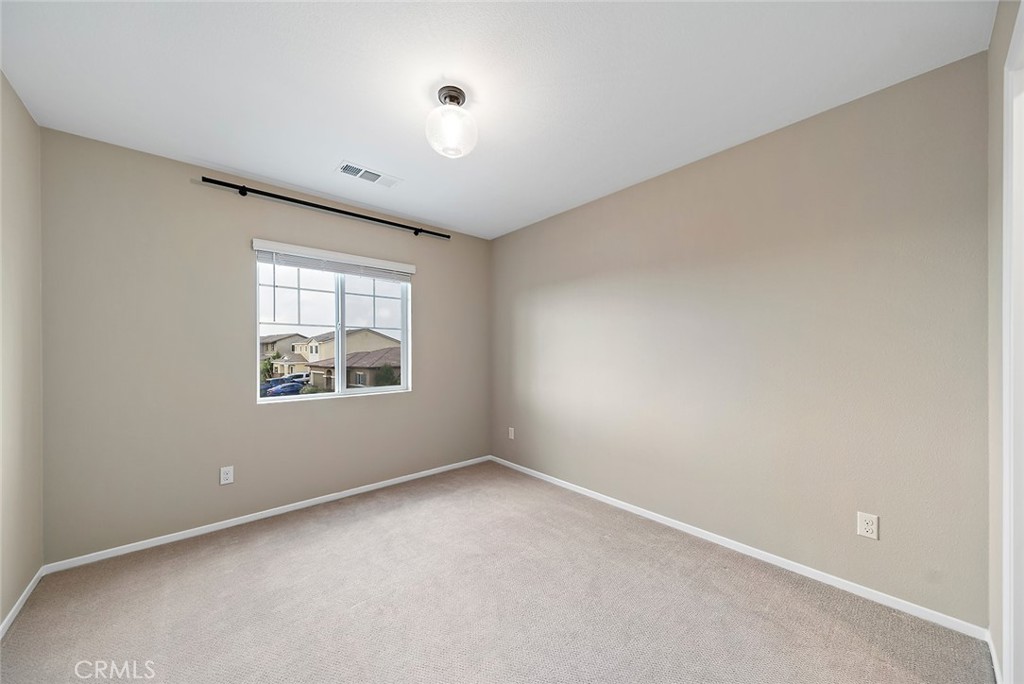 1189 Heritage Drive Calimesa, CA 92320 - Photo 19 of 36 an empty room with windows