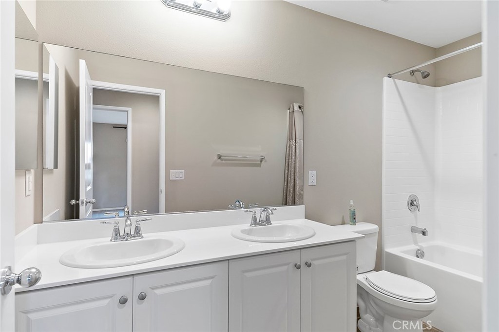 1189 Heritage Drive Calimesa, CA 92320 - Photo 21 of 36 a bathroom with a granite countertop sink toilet and shower
