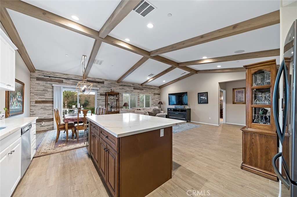 1189 Heritage Drive Calimesa, CA 92320 - Photo 4 of 36 a large kitchen with stainless steel appliances granite countertop a large counter top and a stove