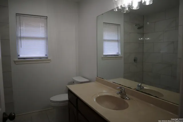 a bathroom with a sink toilet and shower