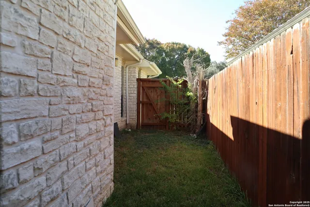 a view of a backyard with pathway