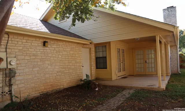 a view of house with backyard