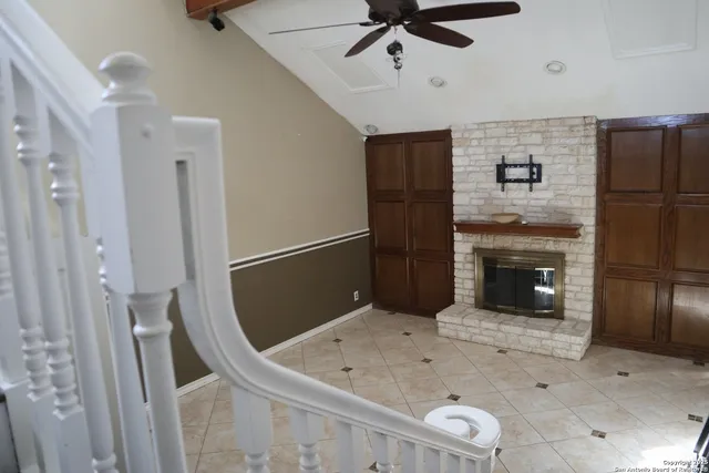 a view of a hallway with entryway wooden floor and staircase