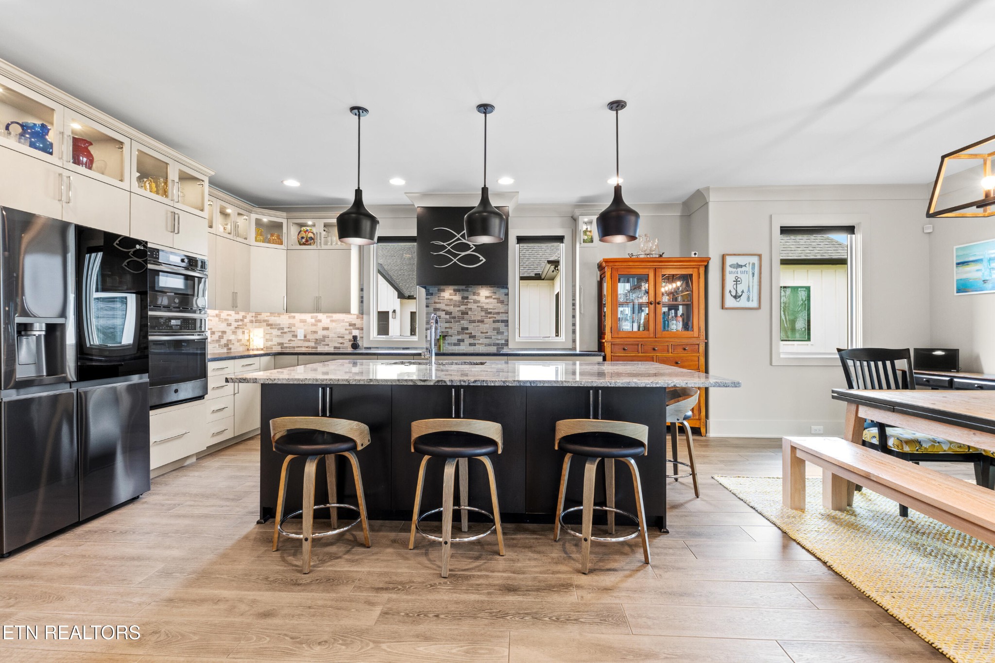 3702 Promontory Point Louisville, TN 37777 - Photo 7 of 60 a dining hall with stainless steel appliances kitchen island granite countertop a dining table chairs and granite counter tops