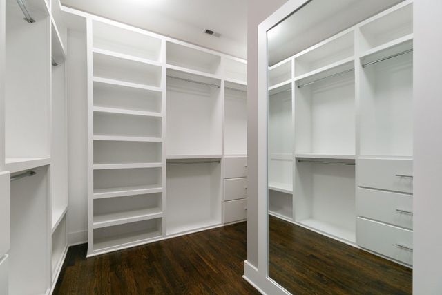 a view of walk in closet with empty racks