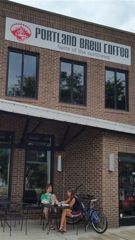 a couple of table and chairs in front of building