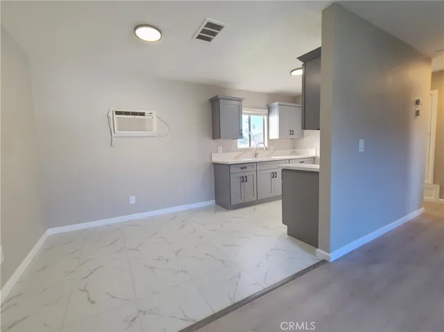 a view of kitchen with granite countertop cabinets and sink