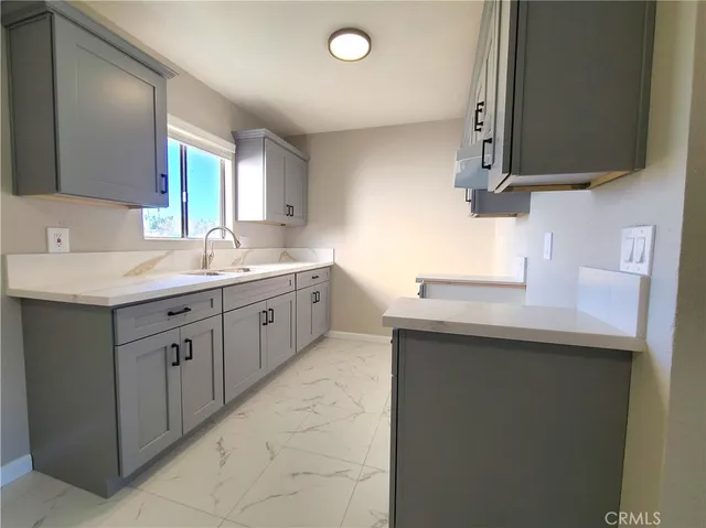 a kitchen with a sink dishwasher a stove and a microwave oven