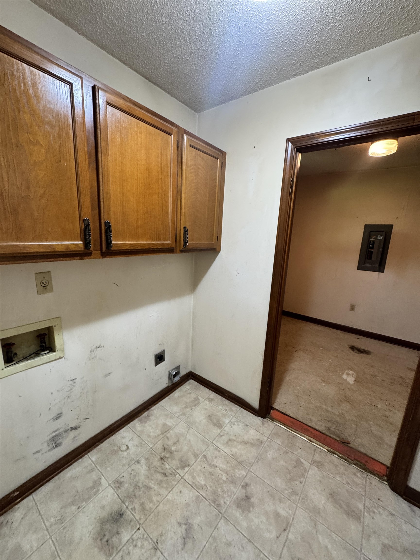 4334 Timber Rise Road Memphis, TN 38125 - Photo 8 of 18 Utility area featuring upper wood cabinetry and tile-look flooring
