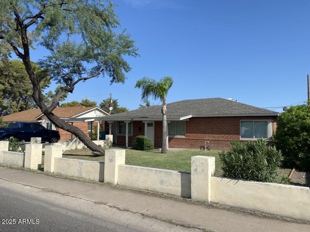 a front view of a house with a garden