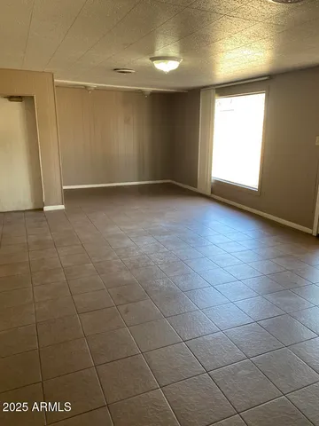 an empty room with a empty space and a window