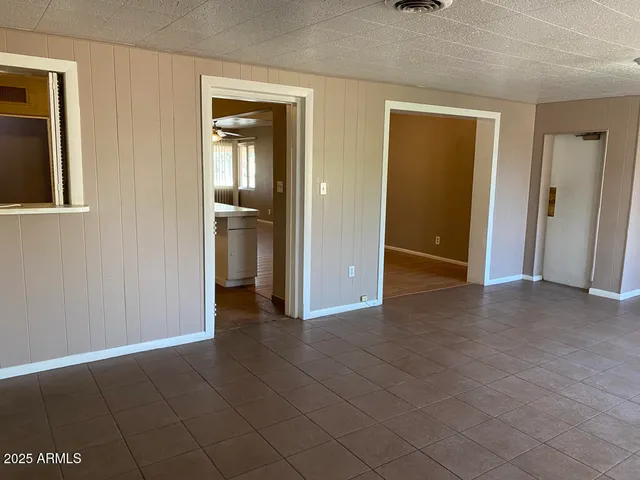 an empty room with windows and entrance