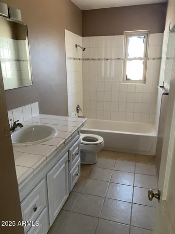 a bathroom with a sink a toilet and bathtub