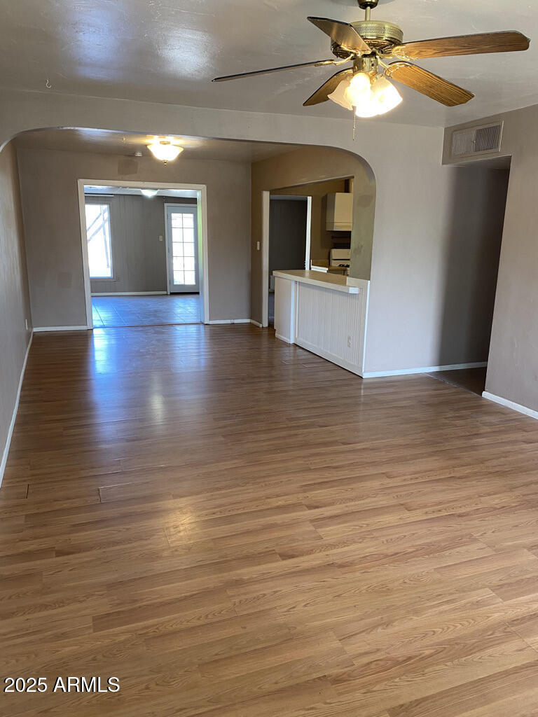 822 West Missouri Avenue Phoenix, AZ 85013 - Photo 5 of 35 an empty room with wooden floor and cabinet