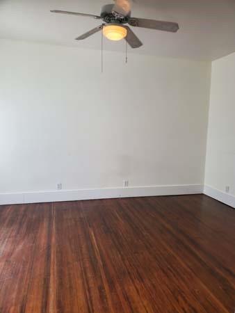921 West Oak Street Denton, TX 76201 - Photo 12 of 23 a view of an empty room with a window and wooden floor