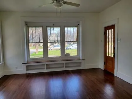 a view of room with wooden floor and fan