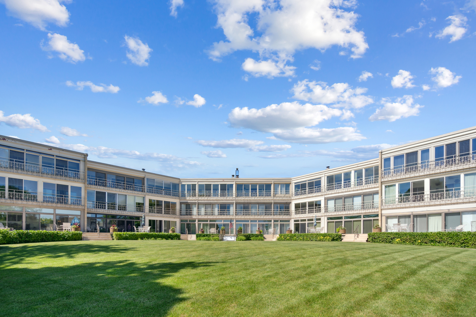 1 North Dee Road, Unit 3H Park Ridge, IL 60068 - Photo 5 of 6 a front view of building with outdoor space and trees in the background