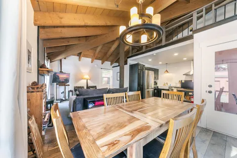 a kitchen with stainless steel appliances granite countertop a refrigerator a sink a stove and a refrigerator