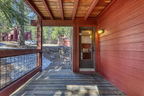 a view of empty room with wooden floor and windows