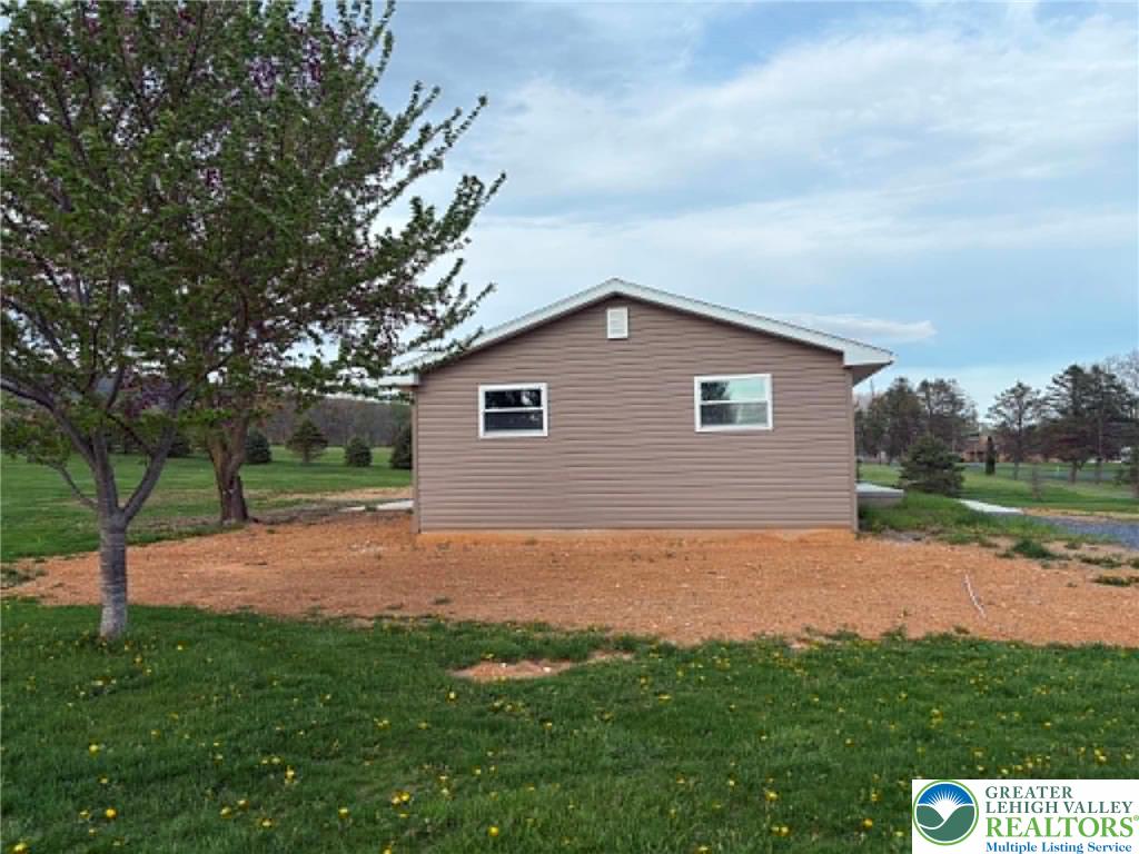 3957 Mountain Road Slatington, PA 18080 - Photo 6 of 33 a backyard of a house with lots of green space and lake view
