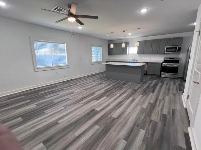 a view with a sink a mirror and cabinets