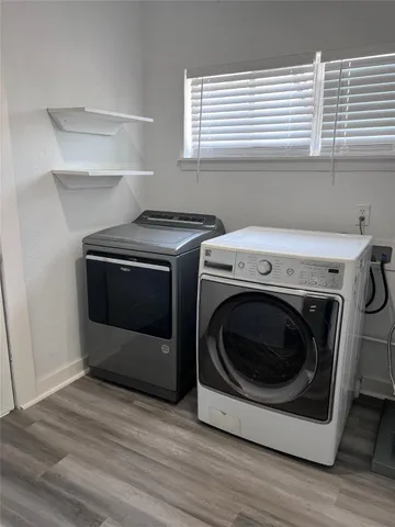 a white house covered with tall trees