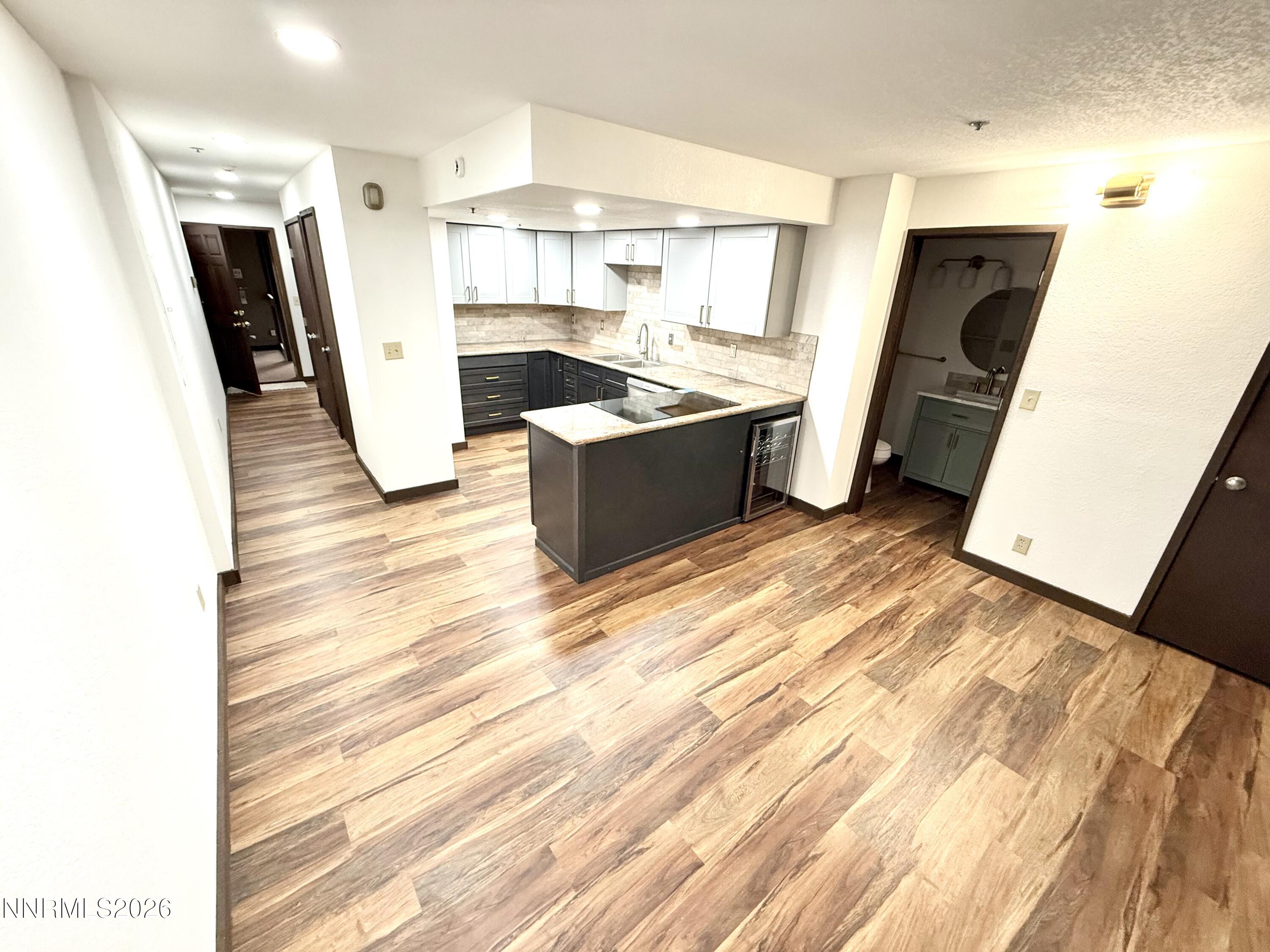 333 Ski Way, Unit 279 Incline Village, NV 89451 - Photo 3 of 43 a large kitchen with a sink and wooden floor