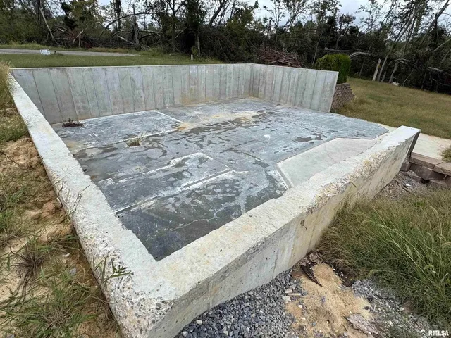 a view of a backyard with wooden fence