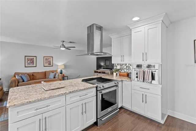 a kitchen with stainless steel appliances granite countertop a refrigerator and a stove