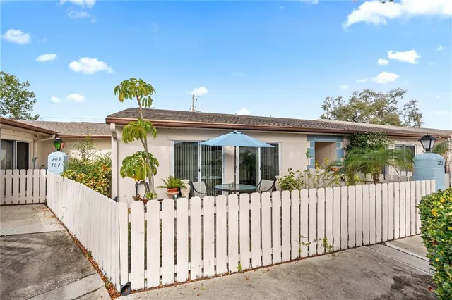 a front view of a house with outdoor seating