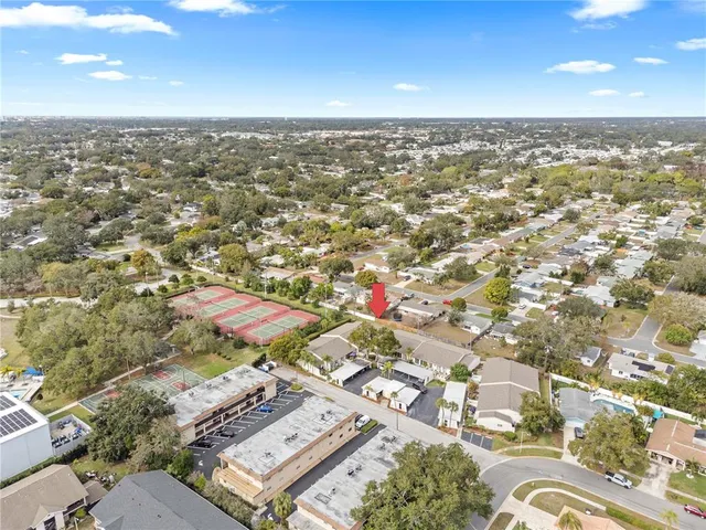 an aerial view of residential houses with city view