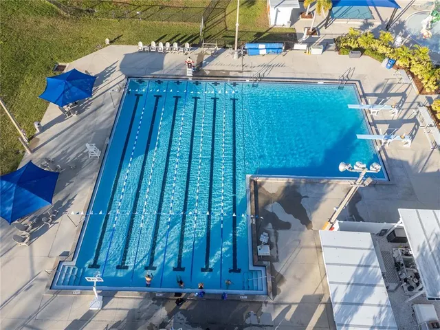 a view of swimming pool with outdoor seating and plants