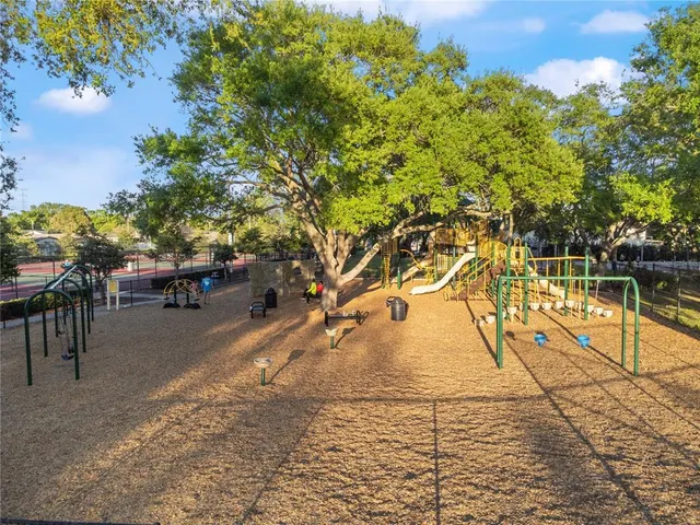 a view of an empty room with a kitchen and a window