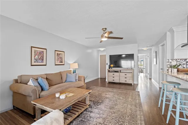 a living room with furniture and a dining table