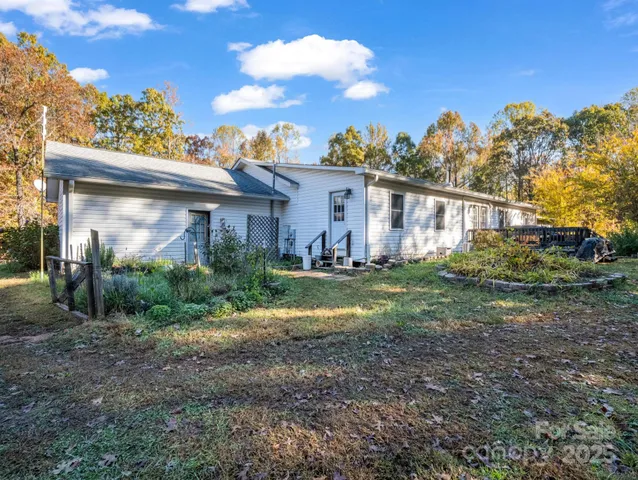 a view of a house with backyard porch and sitting area