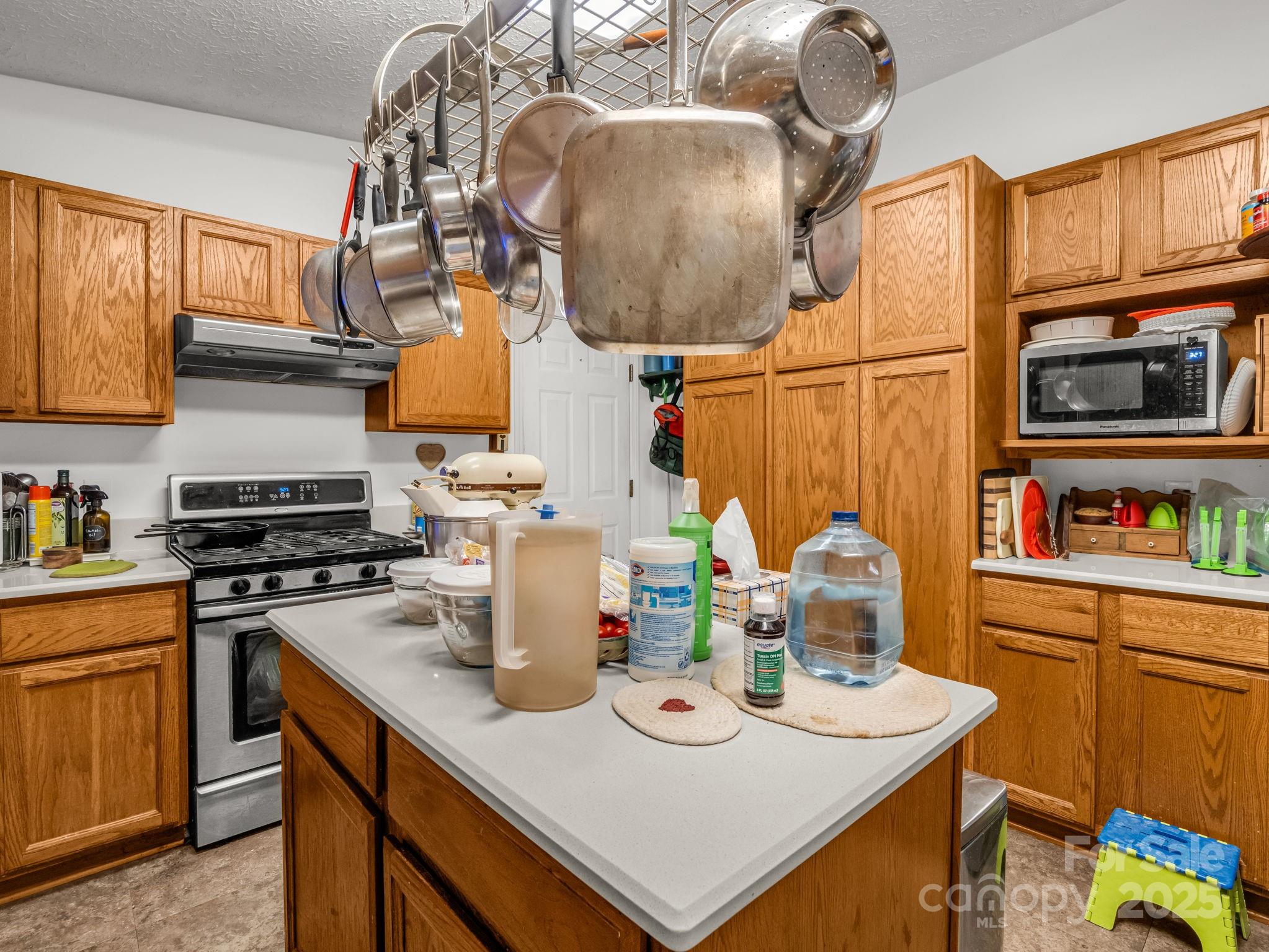 262 Daisy Lane Bostic, NC 28018 - Photo 44 of 48 a kitchen with a sink a stove and chairs