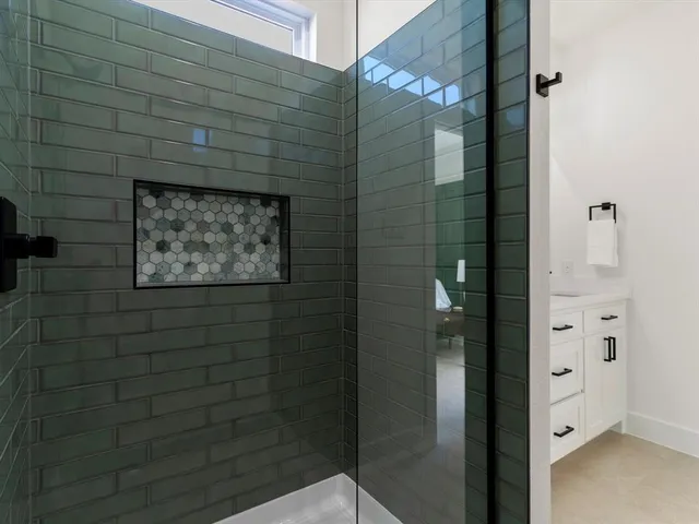 a bathroom with a shower and a sink