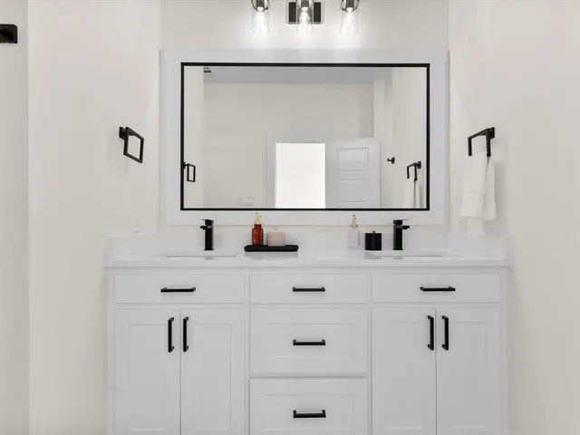 a bathroom with mirror with sink and mirror