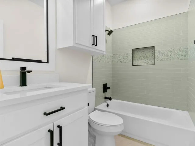 a bathroom with a sink a toilet and bathtub